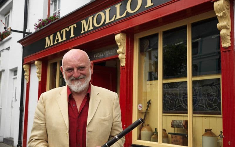 Matt Molloy standing outside his pub in Westport